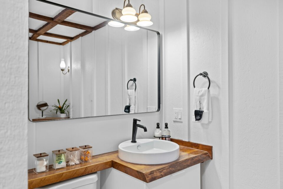 Bathroom wooden white interior design featuring a countertop next to a large wall mirror