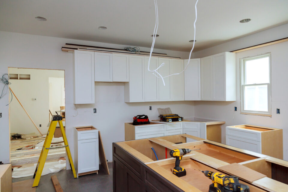 In a set of furniture under construction, white kitchen wooden cabinets were installed