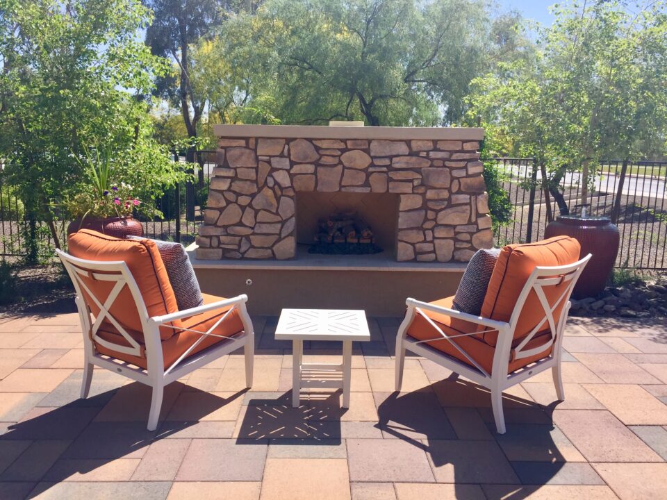 Outdoor fireplace and chairs on a patio 2025 01 10 18 26 10 utc