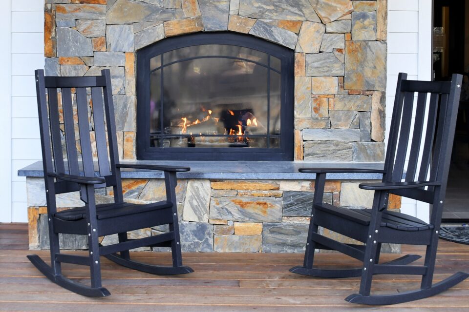 Rocking chairs on a porch in front of a fire at a 2025 03 11 18 35 34 utc