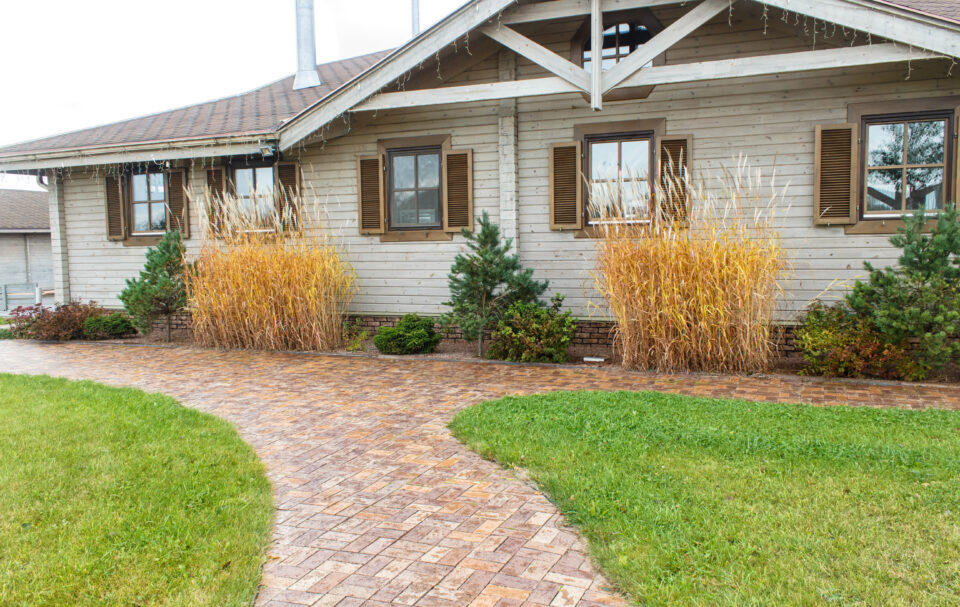 Wooden cottage with green lawn and landscape design